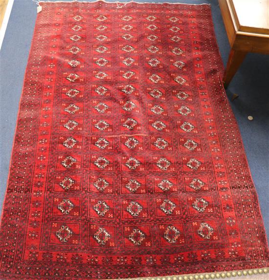 A Belouch red ground rug 187 x 117cm